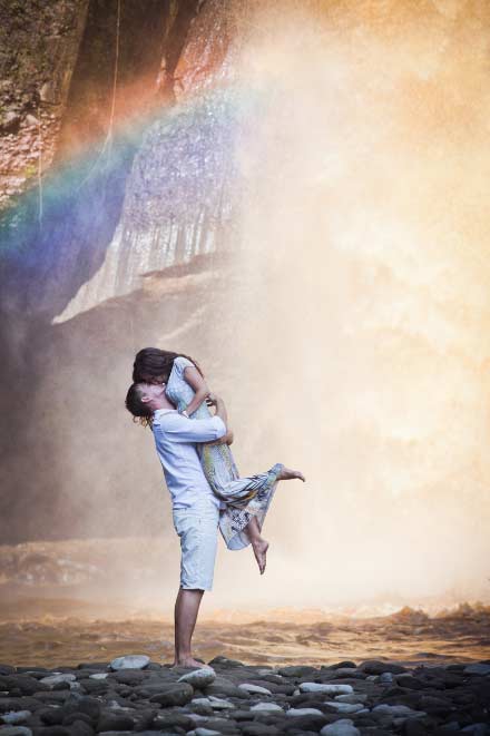A man and a woman standing and kissing in the water